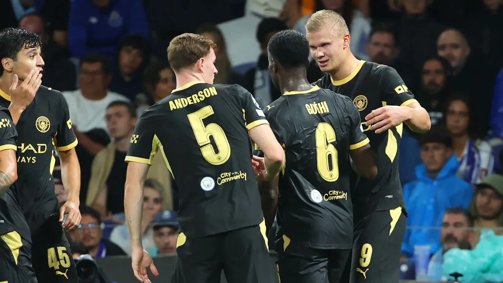 Manchester City players celebrating a goal on field