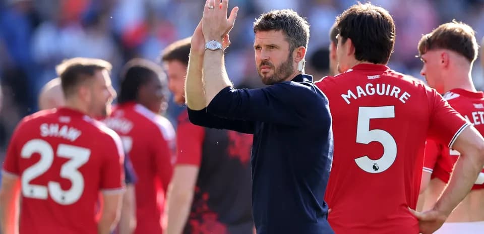 Manager applauding players after match on field