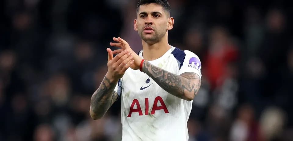 Player applauding fans after match wearing Spurs kit