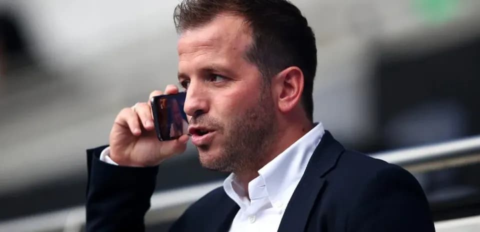 Man talking on phone in stadium seating area
