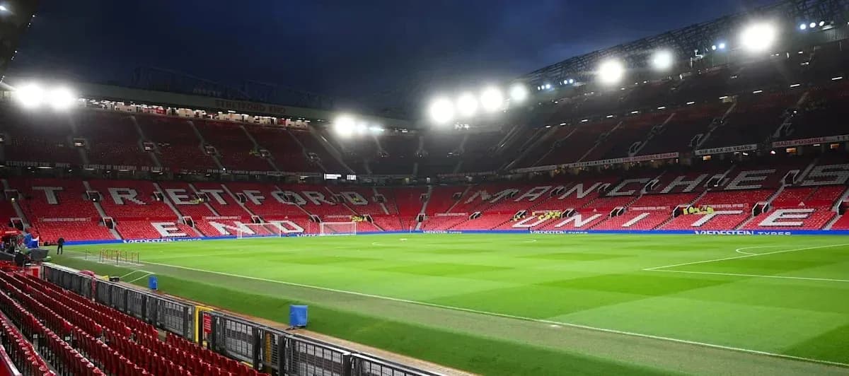Empty Old Trafford stadium with bright floodlights