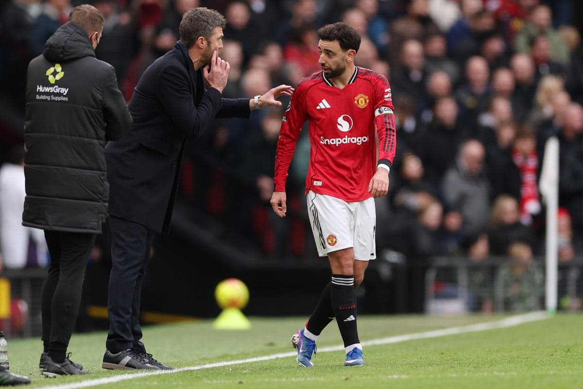 Manager discussing strategy with player during match
