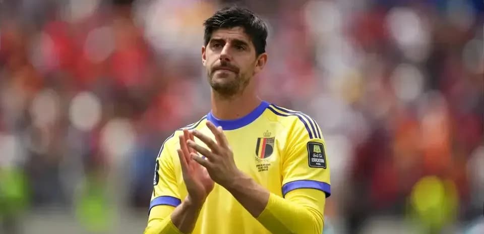 Goalkeeper applauding fans in yellow jersey