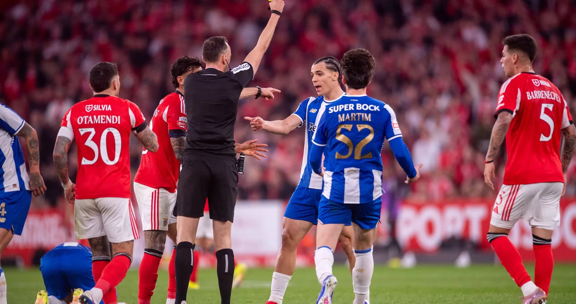 Referee showing yellow card to player during match