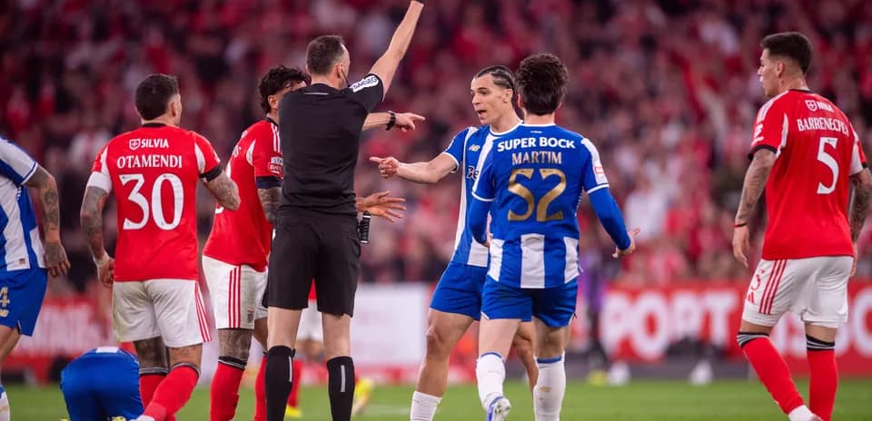Referee showing yellow card to player during match