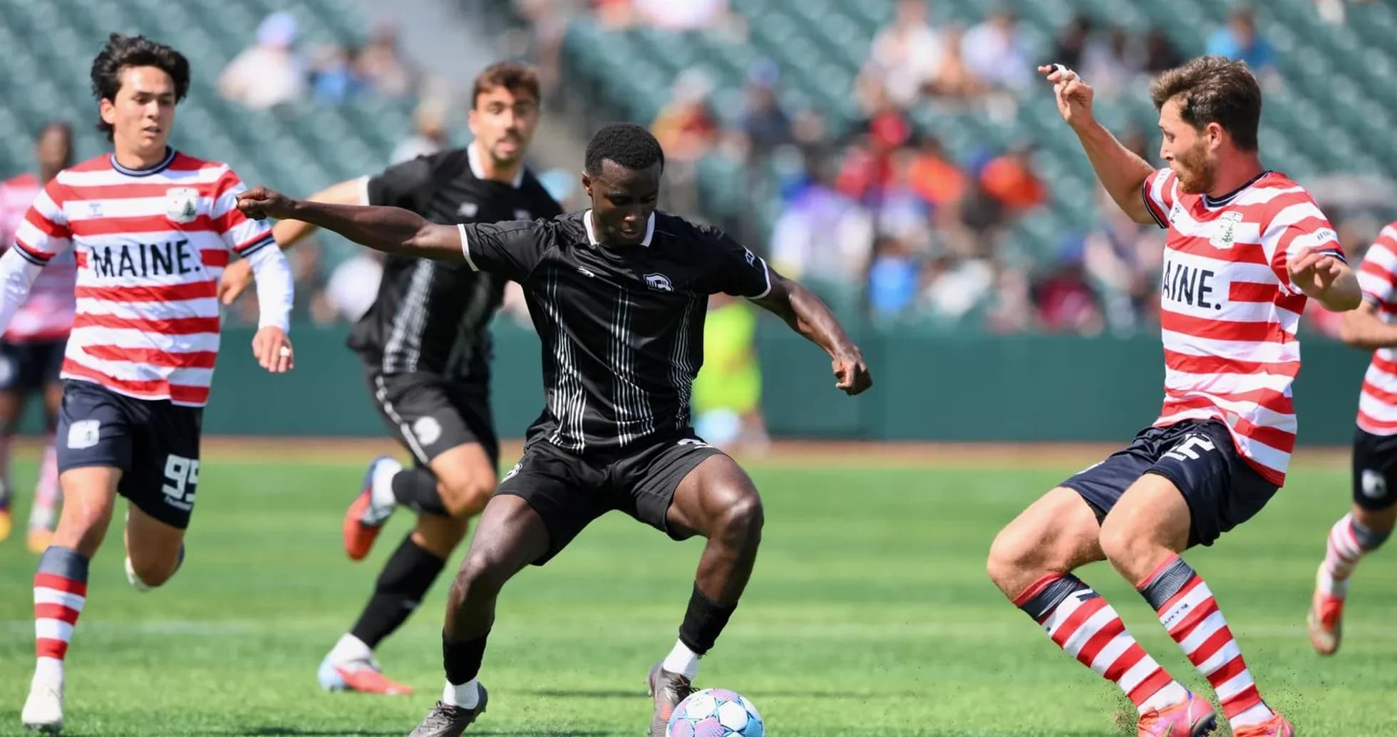 Players competing for the ball in football match