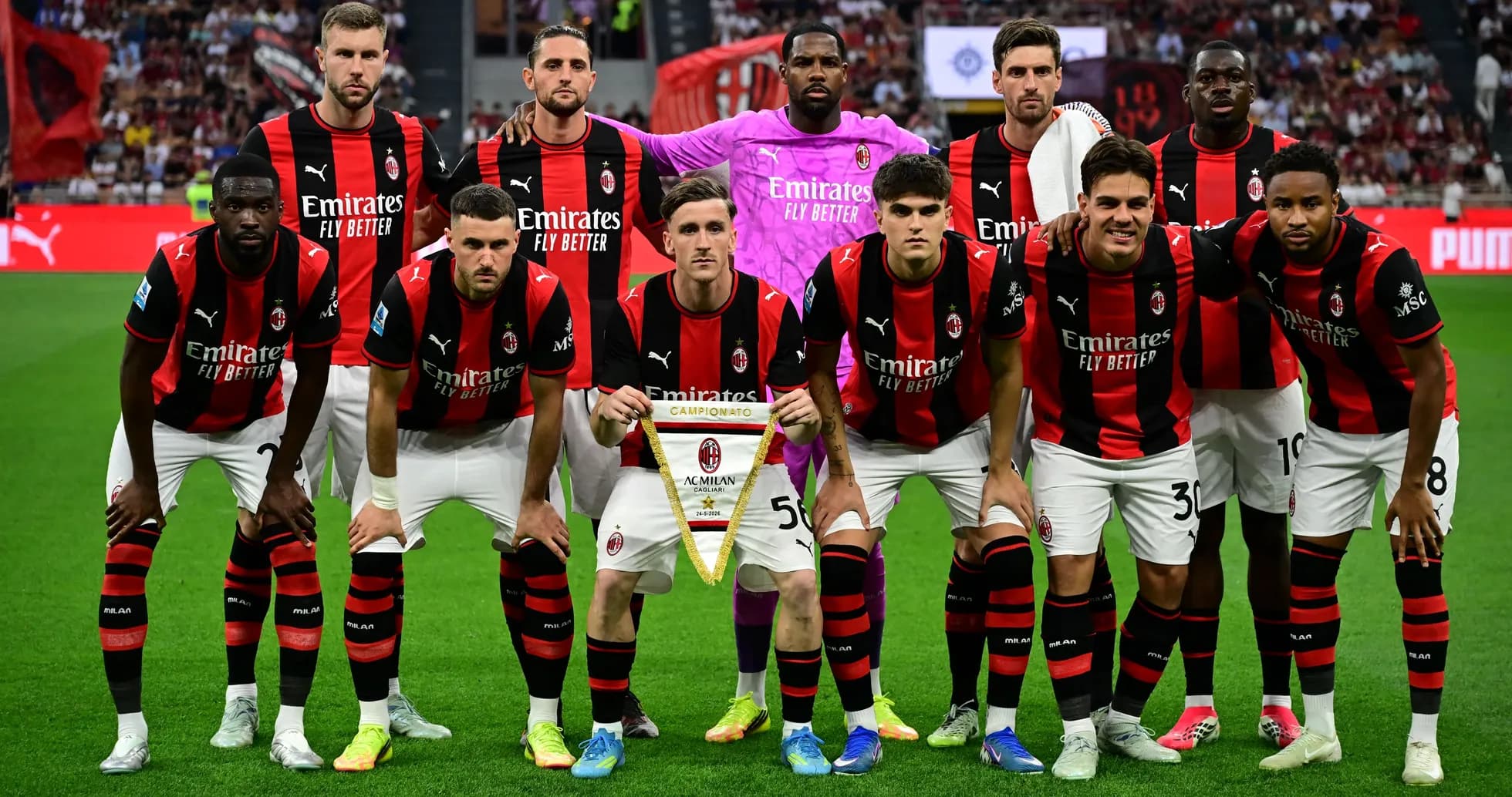 AC Milan players posing with championship banner