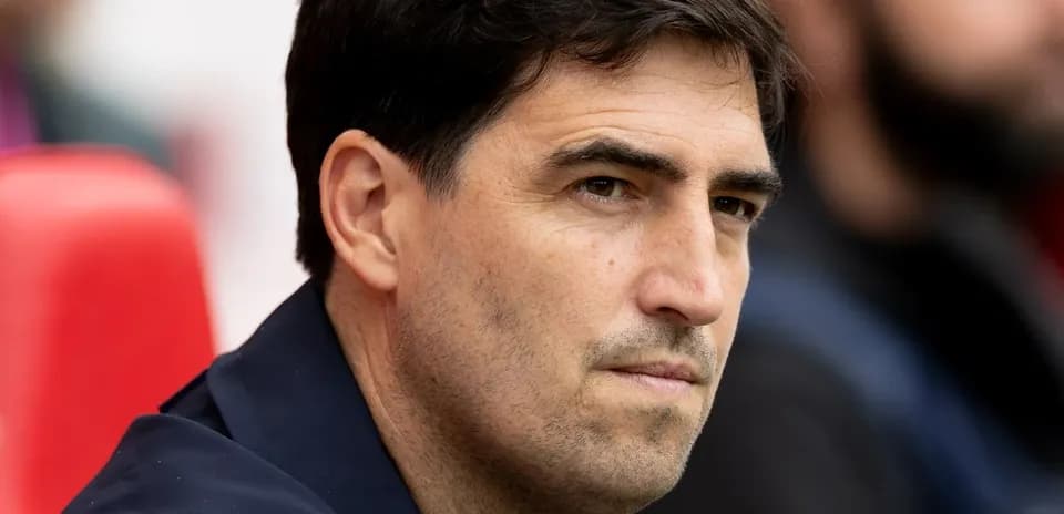 Coach sitting on the bench during a match