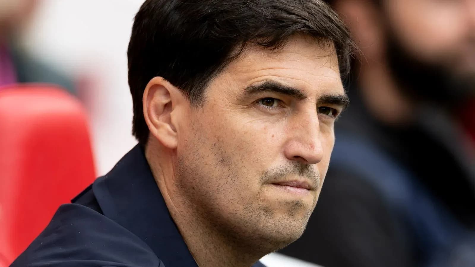 Coach sitting on the bench during a match