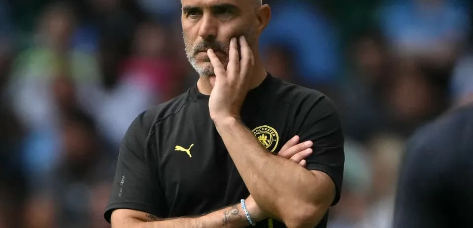 Manager observing the game with thoughtful expression