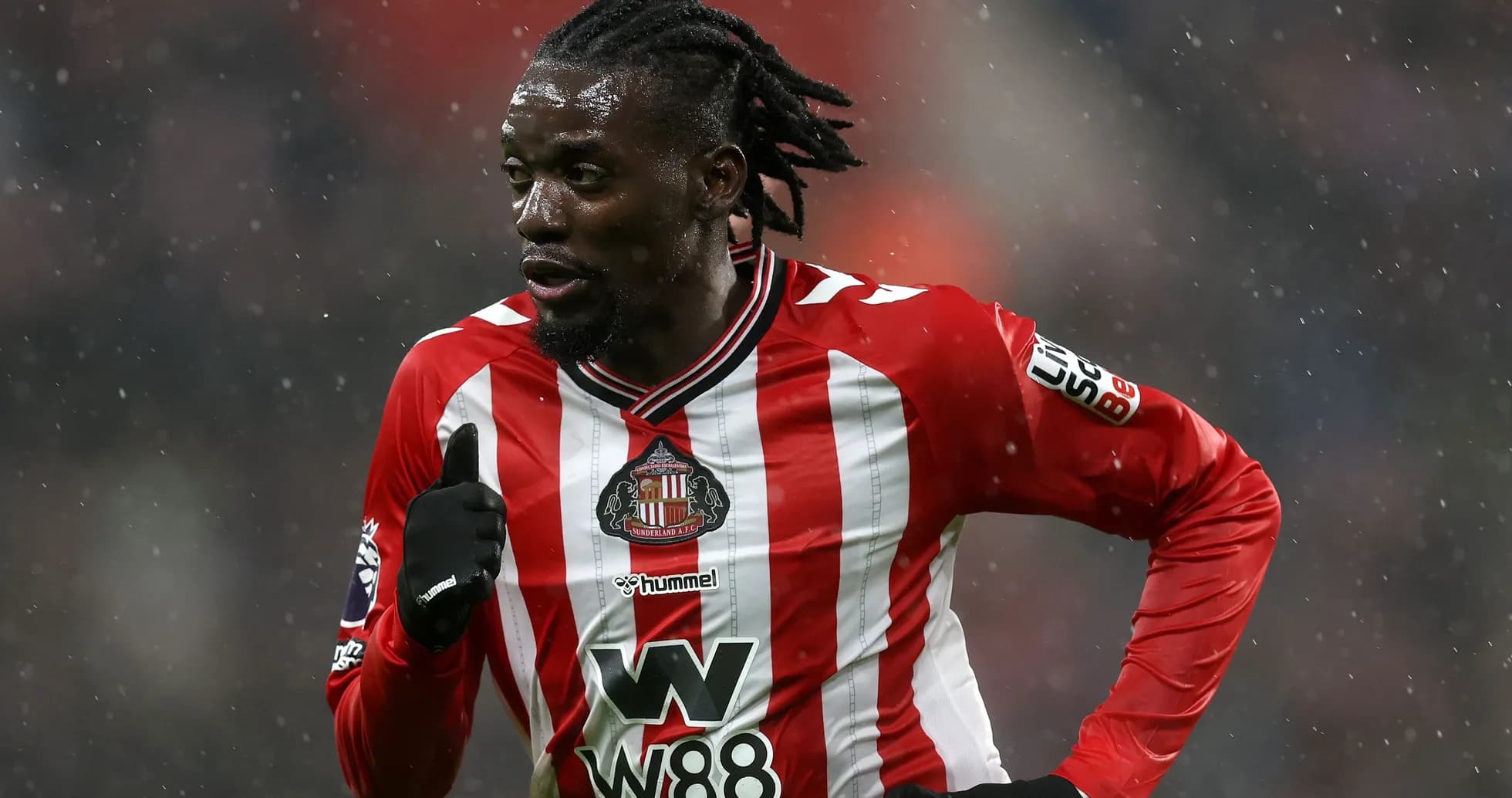 Player running in Sunderland home kit during match