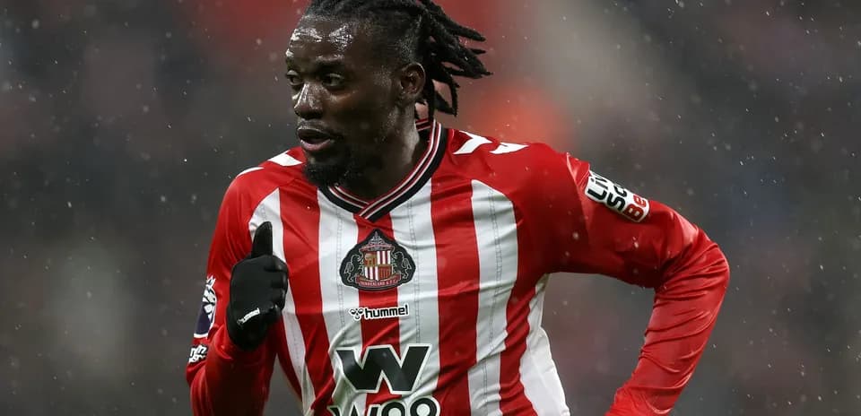 Player running in Sunderland home kit during match