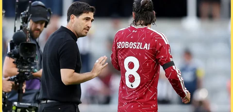 Coach discussing strategy with player Szoboszlai on field