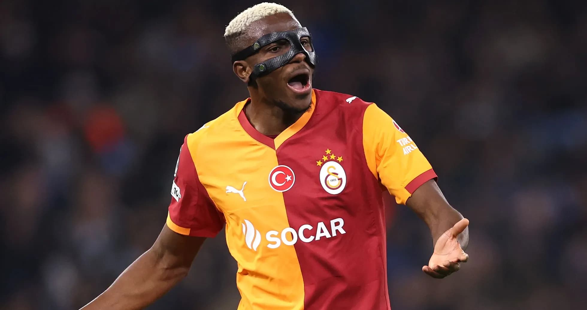 Player celebrating with mask wearing Galatasaray jersey