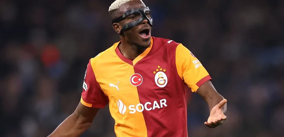 Player celebrating with mask wearing Galatasaray jersey