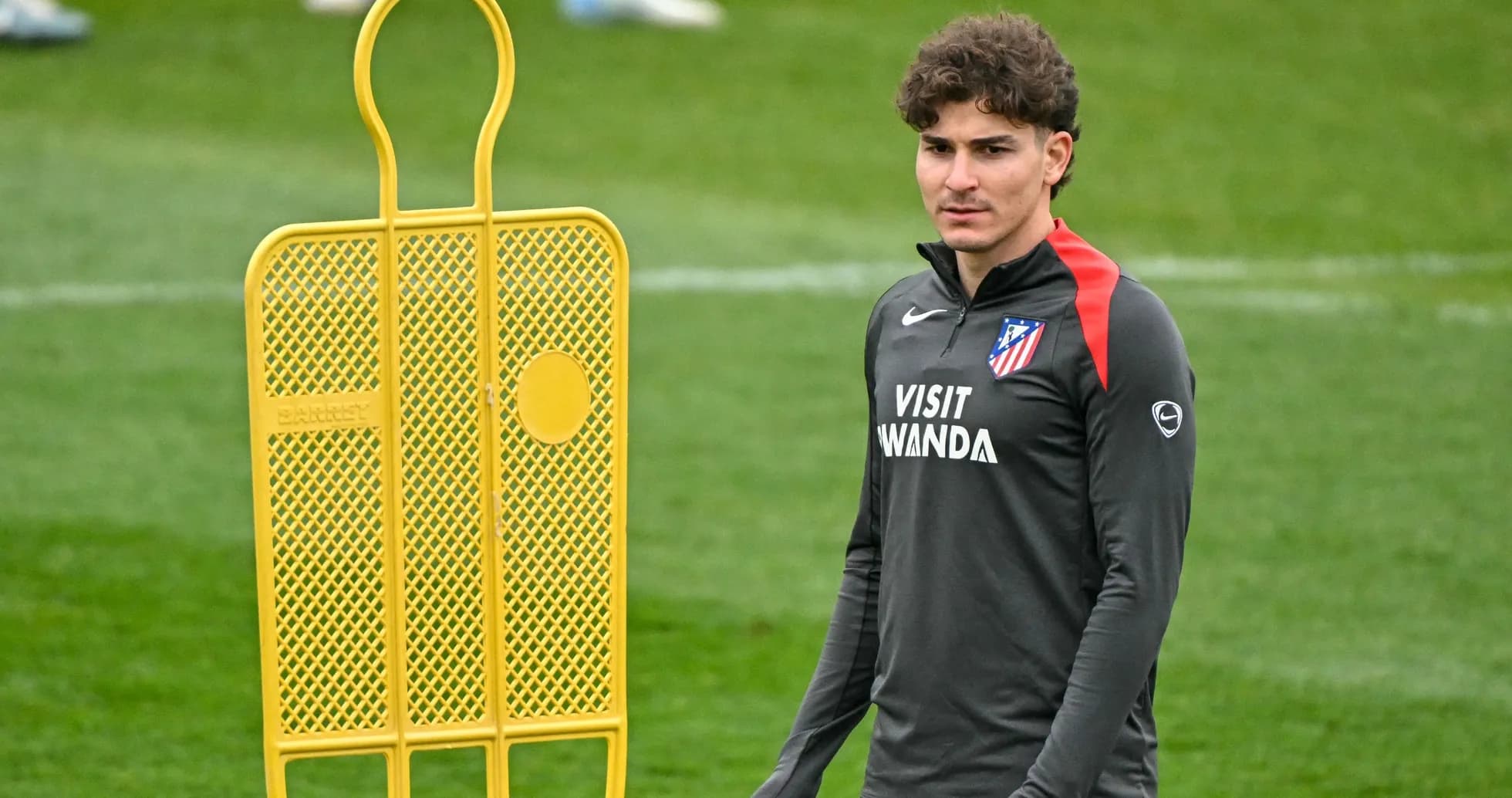 Player in training gear near a training dummy