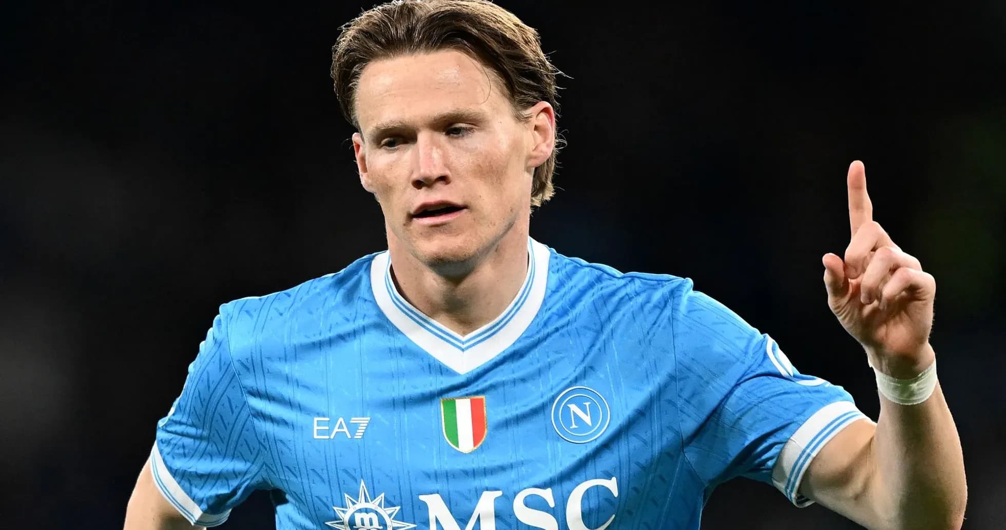 Player celebrating with finger raised in Napoli kit