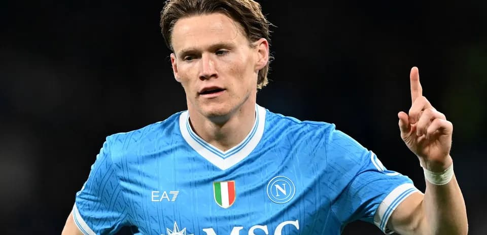 Player celebrating with finger raised in Napoli kit