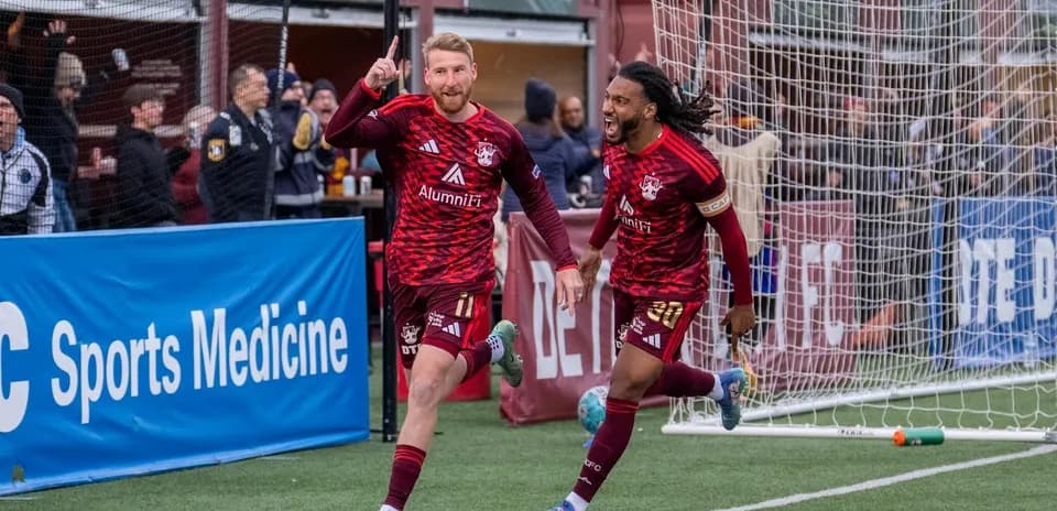 Players celebrating a goal in USL match