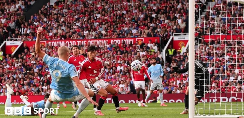 Player shooting towards goal during match at stadium