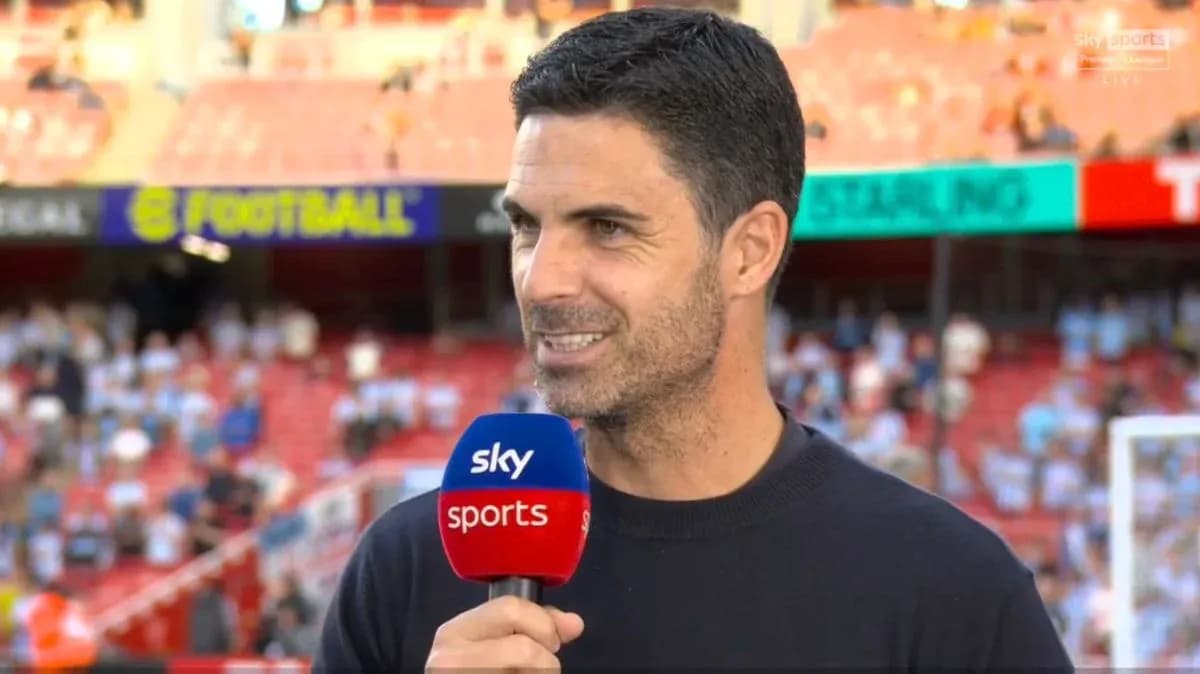 Manager speaking during pre-match interview on field