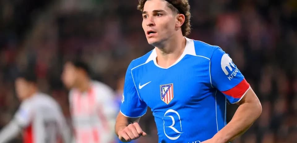 Player in blue Atlético Madrid jersey running on field