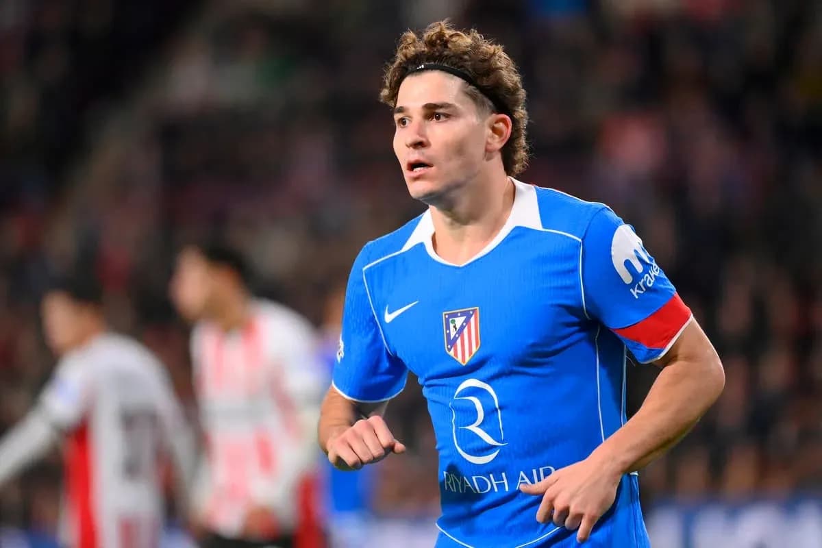 Player in blue Atlético Madrid jersey running on field