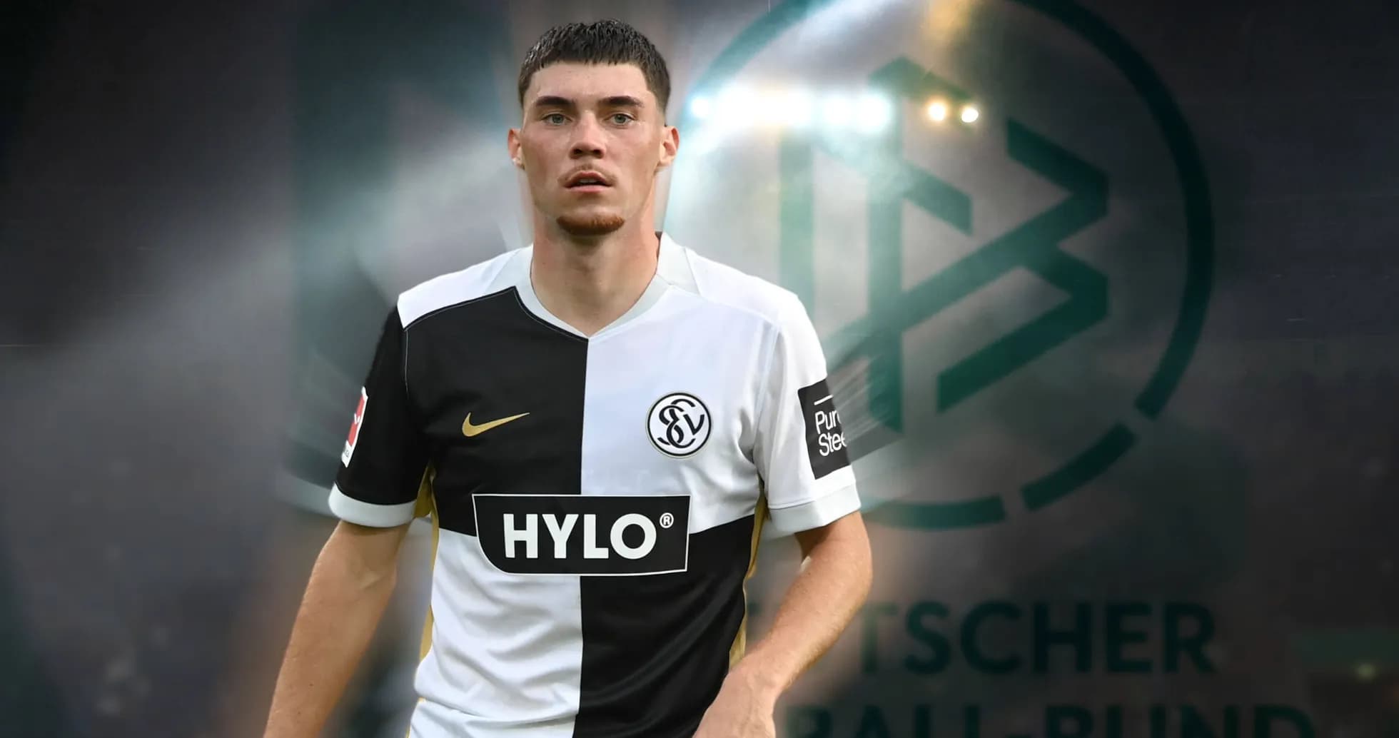 Player in black and white kit on field