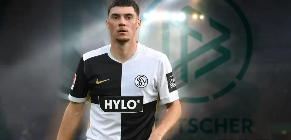 Player in black and white kit on field