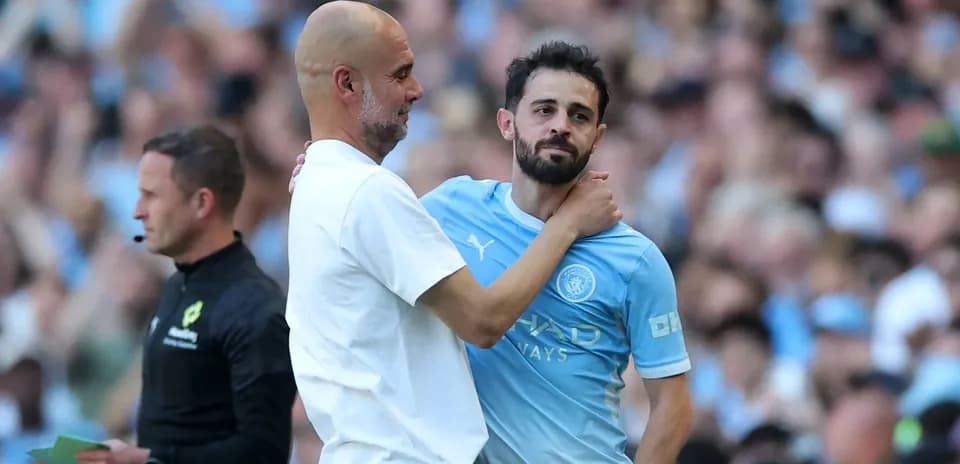 Pep Guardiola embracing Bernardo Silva on the pitch