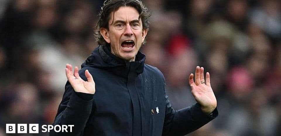 Manager gesturing during a match from the sideline