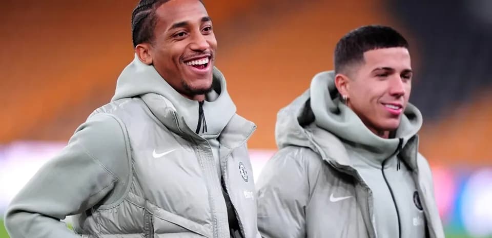 Two players smiling in matching gray jackets