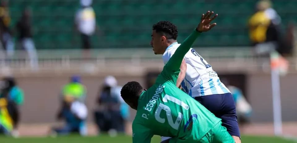 Pyramids FC player competing against GOR Mahia goalkeeper