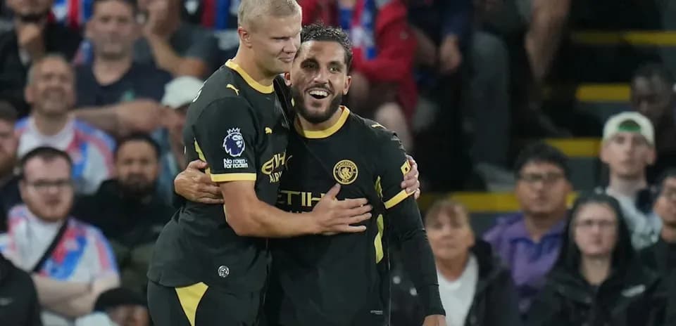 Manchester City players celebrating a goal together