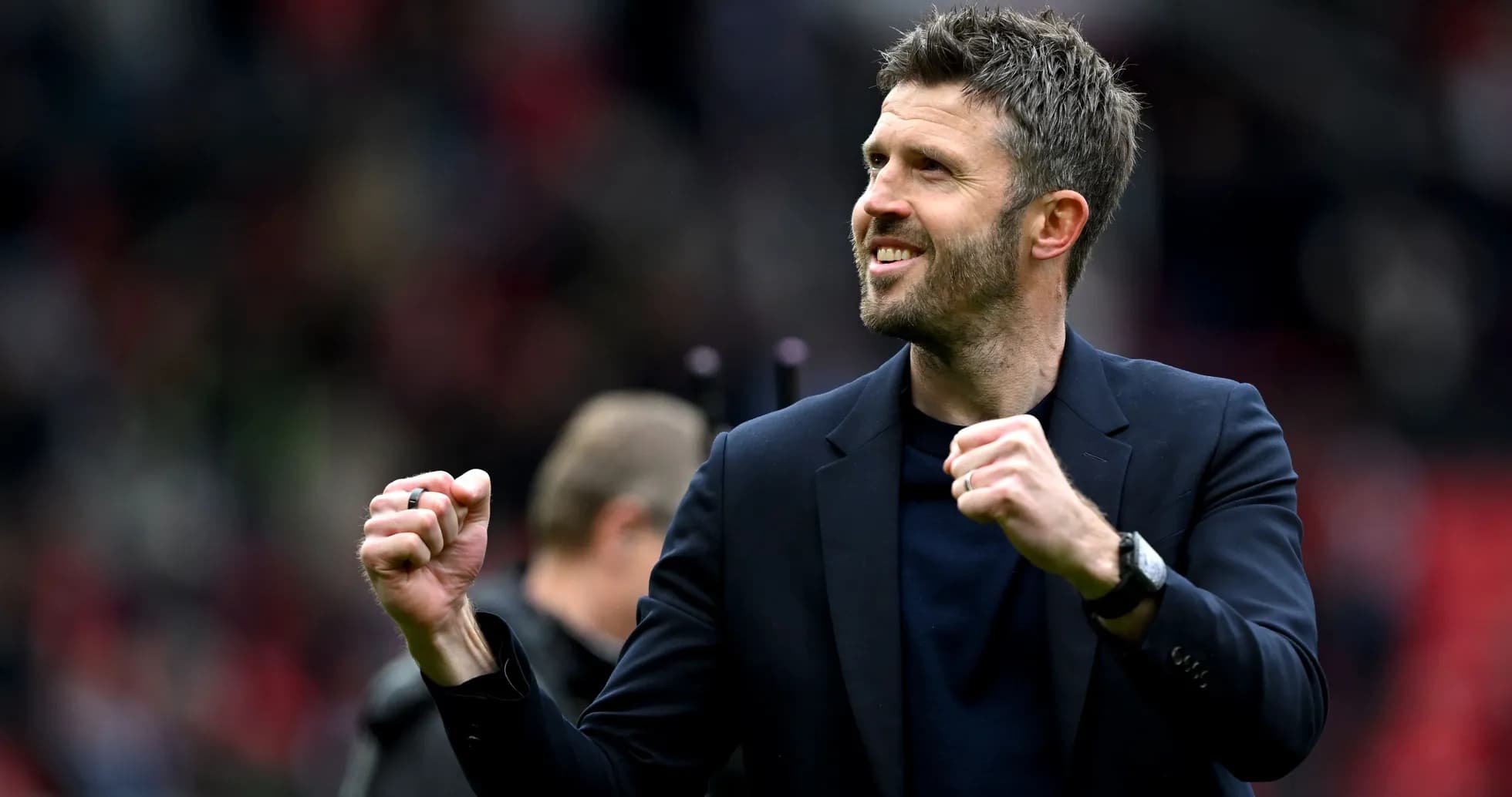 Coach celebrating enthusiastically on the pitch