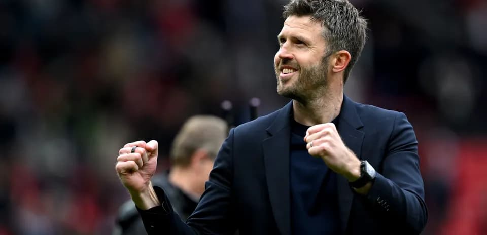 Coach celebrating enthusiastically on the pitch
