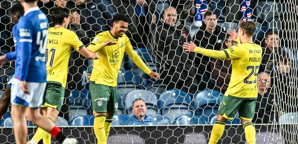 Players celebrating a goal in the netting