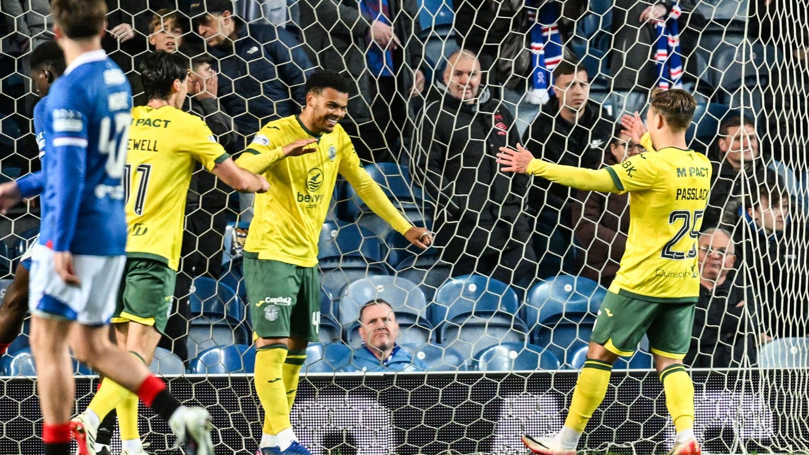 Players celebrating a goal in the netting