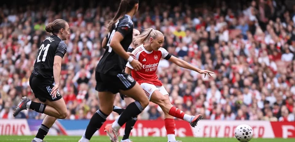 Arsenal player shooting at goal during match
