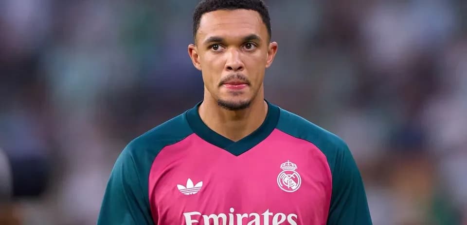 Goalkeeper in pink kit preparing for match