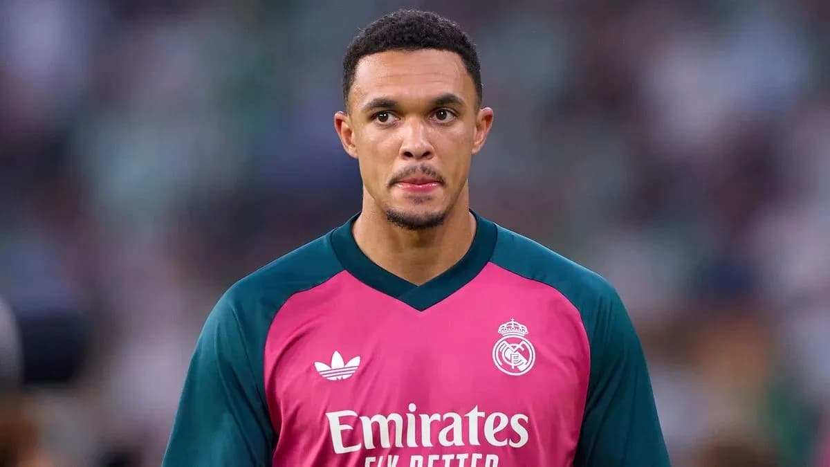 Goalkeeper in pink kit preparing for match