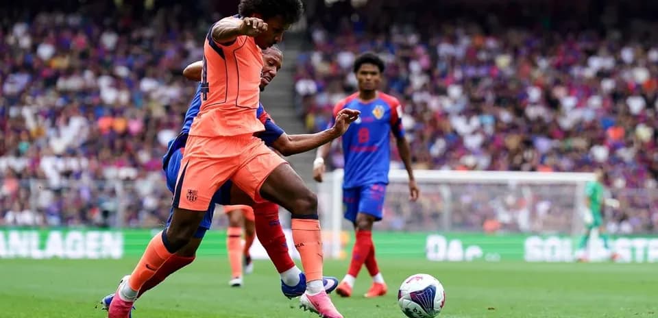 Player in orange jersey tackling opponent in blue jersey