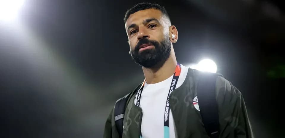 Player walking with a backpack at stadium