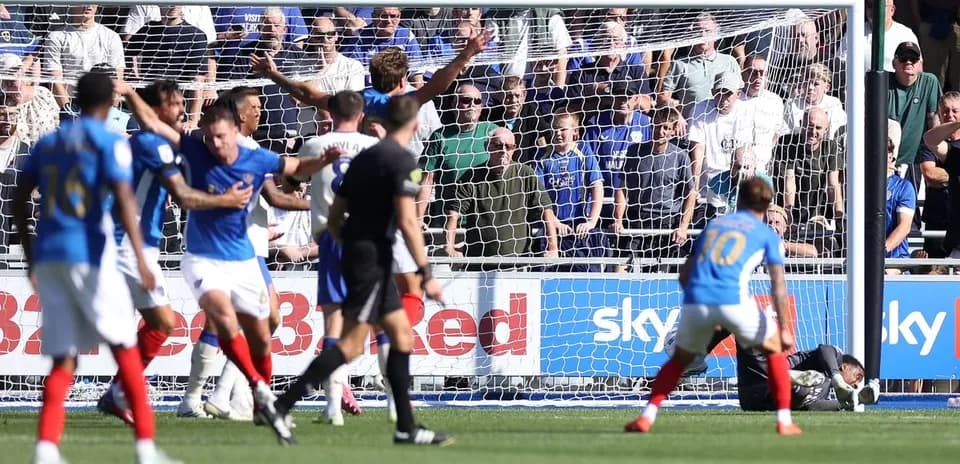Players in action during a goal-scoring moment