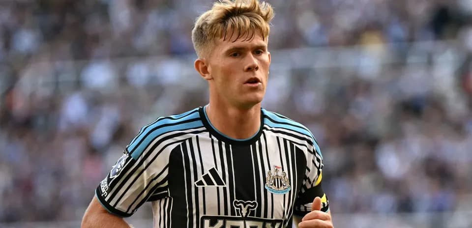Newcastle player running during match at stadium