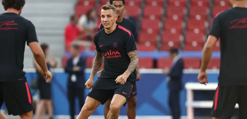Player training on pitch before match warm-up