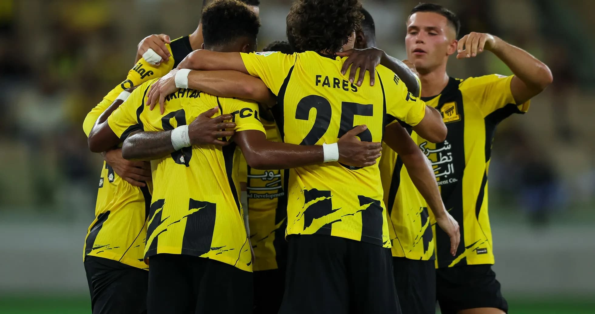 Players celebrating together in yellow team jerseys