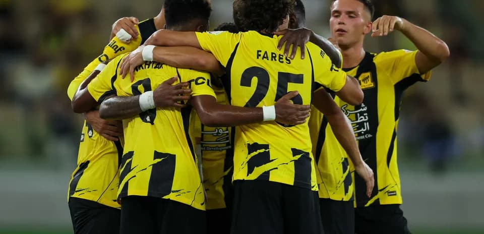 Players celebrating together in yellow team jerseys