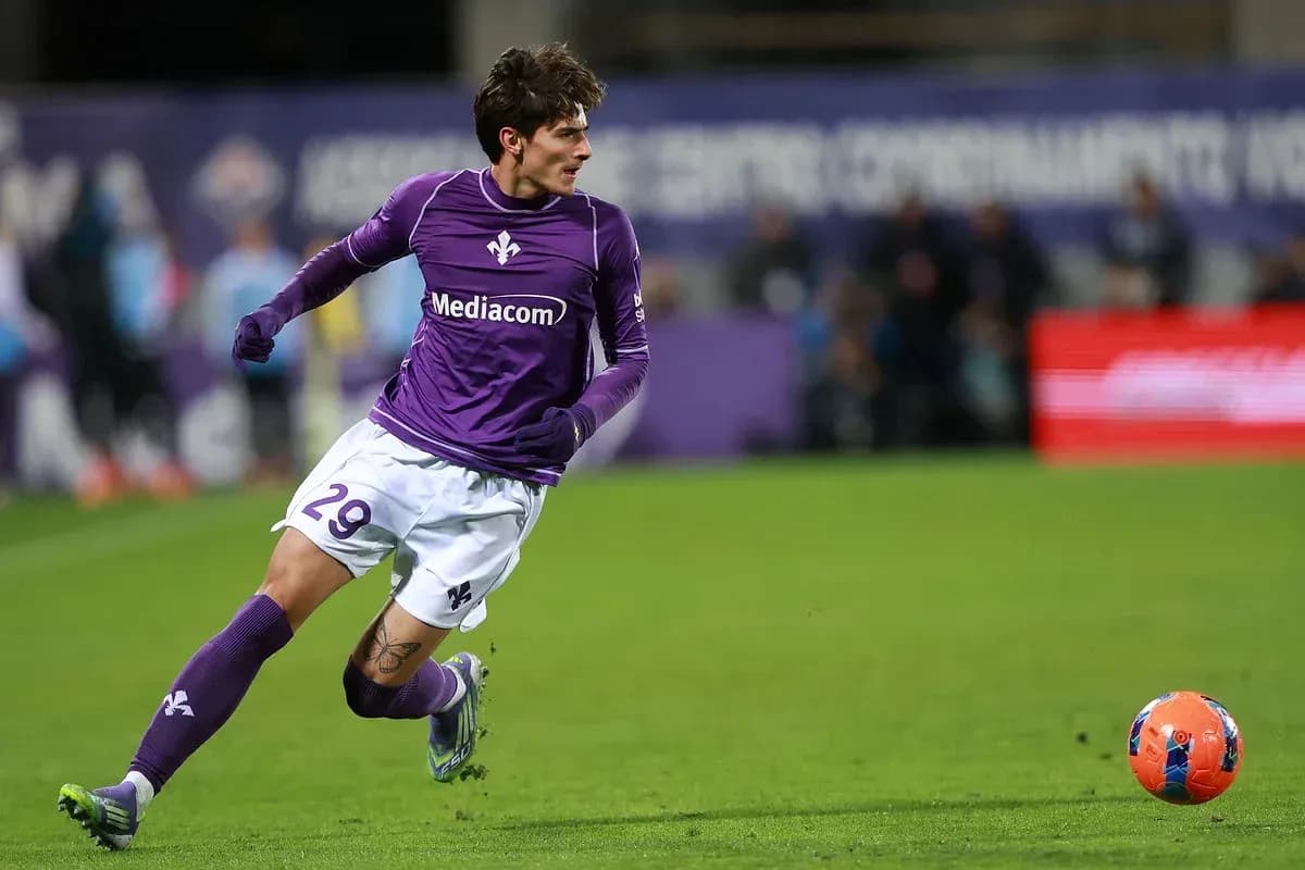 Player in purple jersey sprinting after the ball