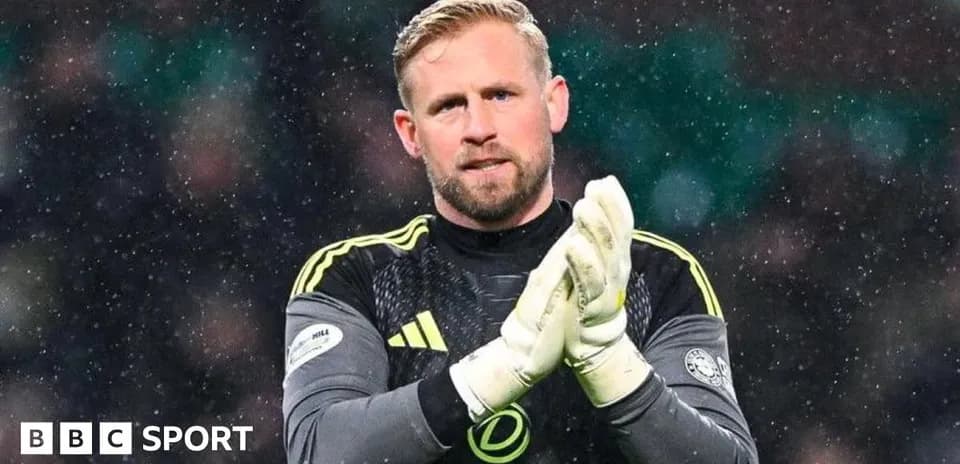 Goalkeeper clapping in snowy stadium environment